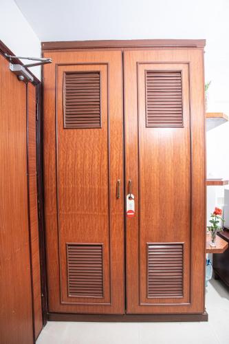 a pair of wooden doors in a room at Silver Mounts Hotel in Phnom Penh