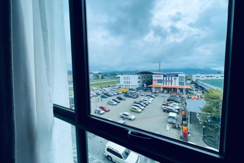 a view of a parking lot from a window at Roxy Hotel Serian in Serian