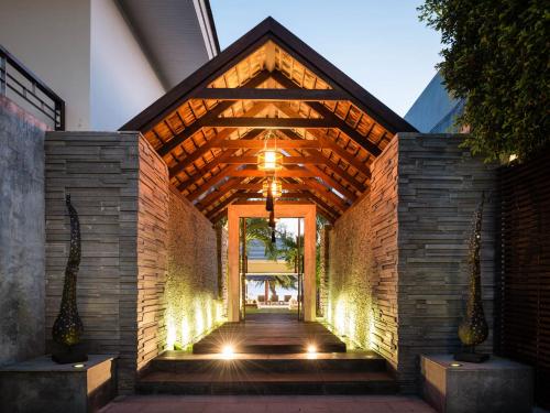 a hallway of a building with a brick wall at Inasia Beach Villa by Elite Havens in Lipa Noi