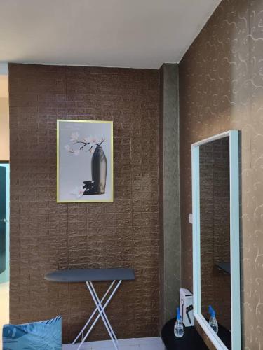 a wall with a picture and a chair in a room at YMT Tambun The Lost World Hideaway in Ipoh