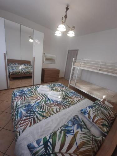 a bedroom with a bunk bed and a mirror at CASA PRIMAVERA in Vado Ligure
