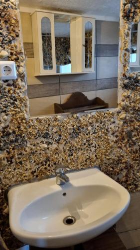 a bathroom with a white sink and a mirror at Modern eingerichtete 3-Zi-Ferienwohnung zu vermieten in Löffingen