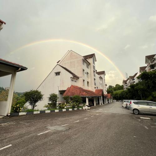 a rainbow in the sky over a building at The Hill Regency in Bentong