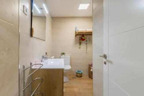 a bathroom with a sink and a toilet at Apartamento mogro playa in Mogro