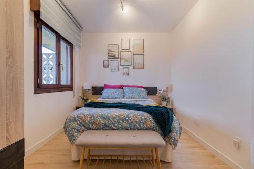 a bedroom with a bed and a chair in it at Apartamento mogro playa in Mogro