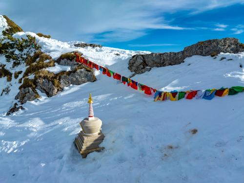 a buddhist prayer line in the snow with a snowy mountain at Le Coucou Hotel Restaurant & Lounge-Bar in Montreux