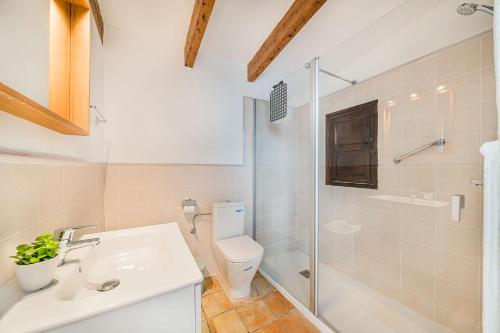 a bathroom with a toilet and a shower and a sink at Noguera -Pollensa in Pollença