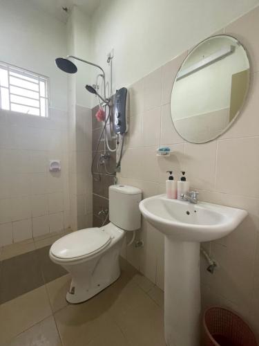 La salle de bains est pourvue de toilettes, d'un lavabo et d'un miroir. dans l'établissement 3R D'Latania Senawang, à Seremban