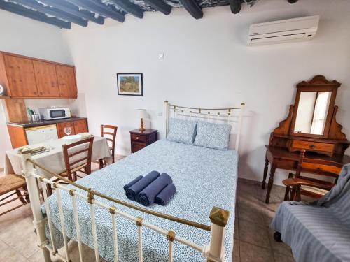 a bedroom with a bed and a table and a piano at Poseidon's Pool Paradise in Skarinou