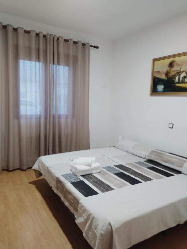 a bedroom with a large bed and a window at NUESTRA SEÑORA DEL PINAR in Galve de Sorbe