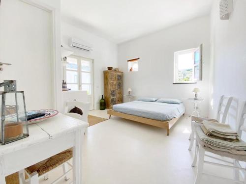 a white room with a bed and a table and chairs at Agata B&B in Lipari