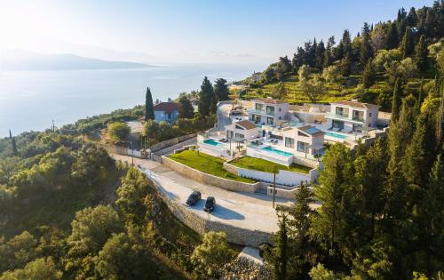 an aerial view of a house on a hill next to the water at Dama Olga Villas in Lygia