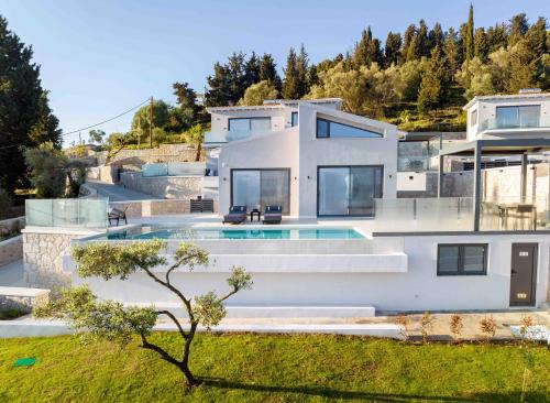 a large white house with a swimming pool at Dama Olga Villas in Lygia