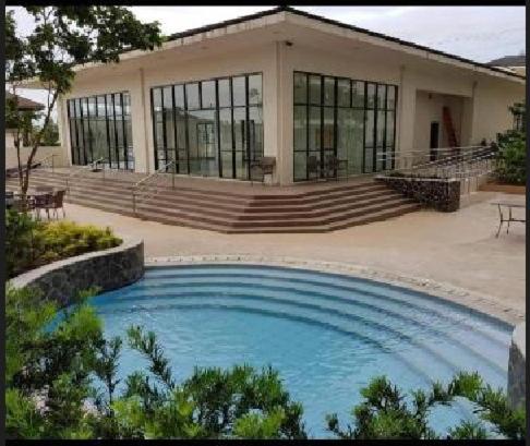a large swimming pool in front of a building at SERIN WEST TAGAYTAY-Spacious & Comfy 2BR Unit with Parking and Balcony in Tagaytay