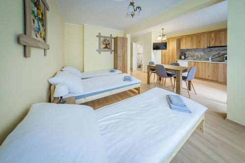 a hospital room with two beds and a table at Stara Piekarnia - Studio Dworcowa in Olsztyn