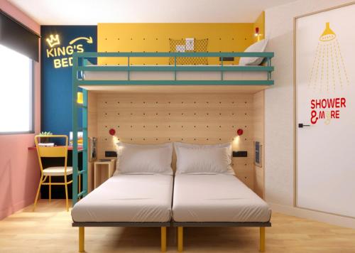 a bedroom with a bed with a bunk bed at Premiere Classe Marseille Vitrolles Aéroport in Vitrolles
