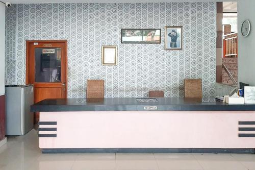 a restaurant with a counter in a room at Urbanview Hotel Istana Bangun Jagad Indramayu by RedDoorz in Indramayu