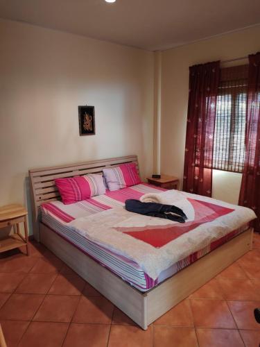 a bedroom with a bed with pink and white sheets at Seabreeze 145 by malai in Rayong