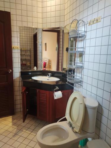 a bathroom with a toilet and a sink at Seabreeze 145 by malai in Rayong