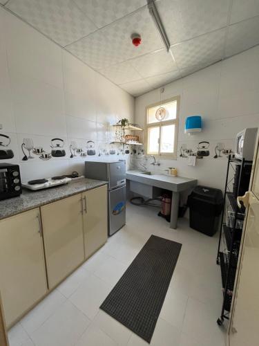 a kitchen with a counter and a sink in it at شقة الفخامة in Sharīyah