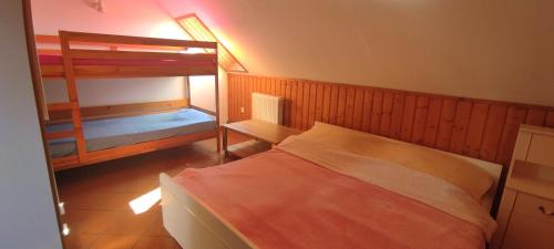 a small bedroom with two bunk beds and a lamp at Przy Kominku Polanica-Zdrój in Polanica-Zdrój