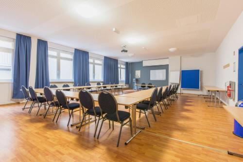 a conference room with a long table and chairs at a&o Dortmund Hauptbahnhof in Dortmund