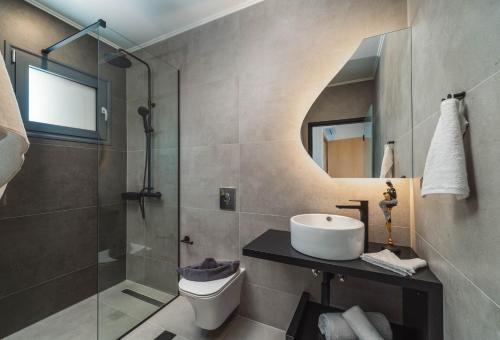 a bathroom with a sink and a shower at Dama Olga Villas in Lygia