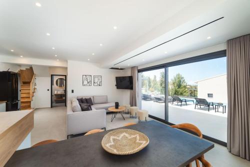 a kitchen and living room with a table and a couch at Dama Olga Villas in Lygia