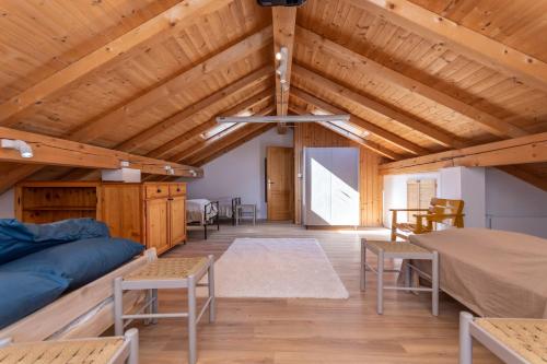 a large room with a wooden ceiling with beams at Casa Narciso in Rocca Pietore