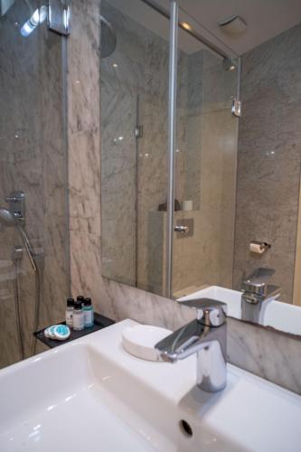 a bathroom with a sink and a mirror at Hotel Atina in Budva