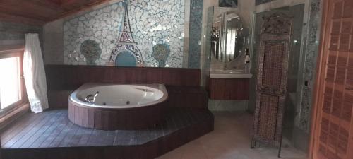 a bathroom with a large tub and a shower at Bc Spa Hotel in Dalyan