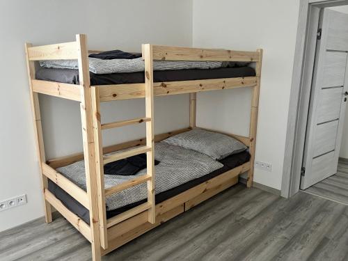 a pair of bunk beds in a room at Kozákov Apartmány - druhé patro in Kozákov