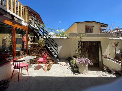 a patio with two chairs and a table and a building at Timeless Inn in Shangri-La