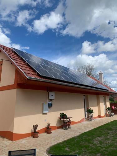 a house with solar panels on the roof at Szent István Wellness Panzió in Makó