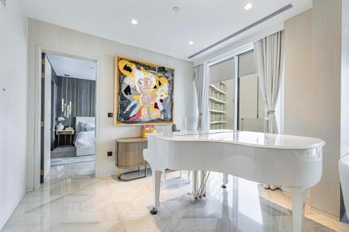 a white tub in a room with a painting on the wall at Daniels 2BR Five Palm Breathtaking view in Dubai