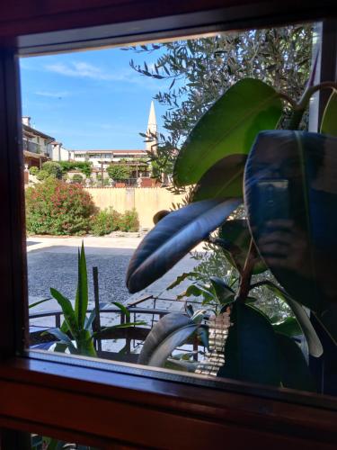 a window with a view of a street and a church at Ostello Europa in San Vito al Tagliamento