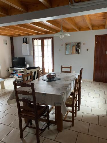 une cuisine et une salle à manger avec une table et des chaises dans l'établissement Bergerie rénovée au coeur des Pyrénées, à Campan