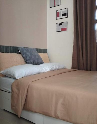 a bed sitting in a bedroom with a window at Flexi Unit 1BR or 2BR convertible at South Residences Las Pinas in Manila