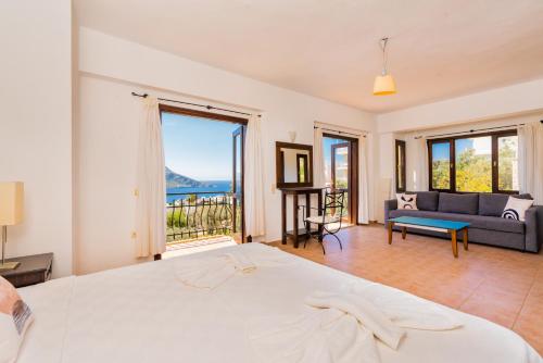 a bedroom with a bed and a view of the ocean at Villa Vista Mare in Kalkan