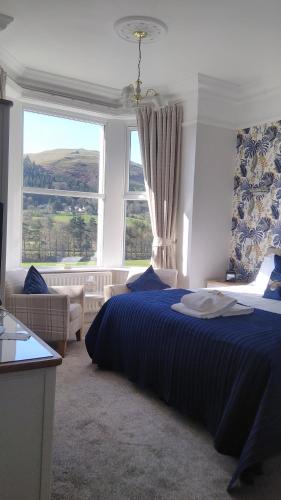 a bedroom with a bed and a large window at Link House in Bassenthwaite Lake