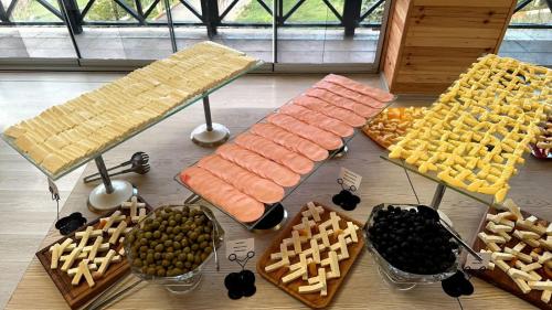 a bunch of food on a table with baskets of food at Deluxe Park Qusar Resort & Spa Hotel in Qusar