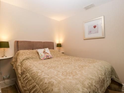 a bedroom with a bed with a pillow on it at Brook Cottage in Abergavenny