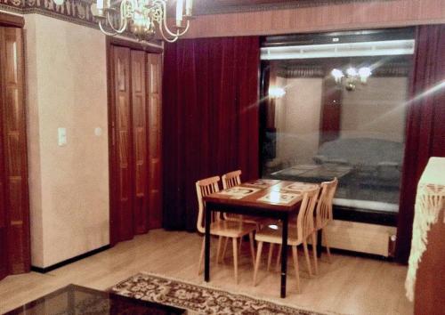 a dining room with a wooden table and chairs at Beautiful terraced house / Kaunis rivitalokaksio in Tampere