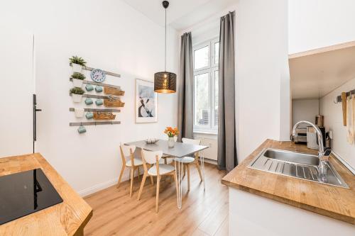a kitchen with a sink and a table at Stylish New Cube Loft II by Berlin-Wall-Apartments in Berlin