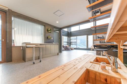 a kitchen with wooden floors and a large window at Hinokki Haesuzzim Resort in Geoje 