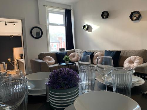 a living room with wine glasses and a couch at Windsor 4 - Spacious beautiful 4 bdrm maisonette nr Ncle free wifi free parking in Gateshead