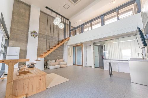 a living room with a staircase and a couch at Hinokki Haesuzzim Resort in Geoje 