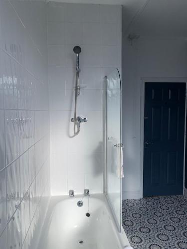 a white bathroom with a shower and a tub at Windsor 4 - Spacious beautiful 4 bdrm maisonette nr Ncle free wifi free parking in Gateshead