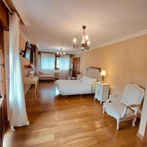 a large living room with a bed and chairs at Caserio Kamirune in Laukiz