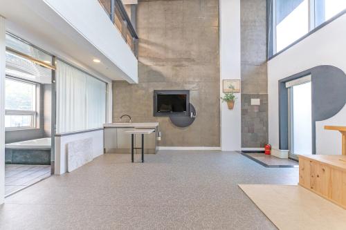 a large room with a sink and a tv on a wall at Hinokki Haesuzzim Resort in Geoje 